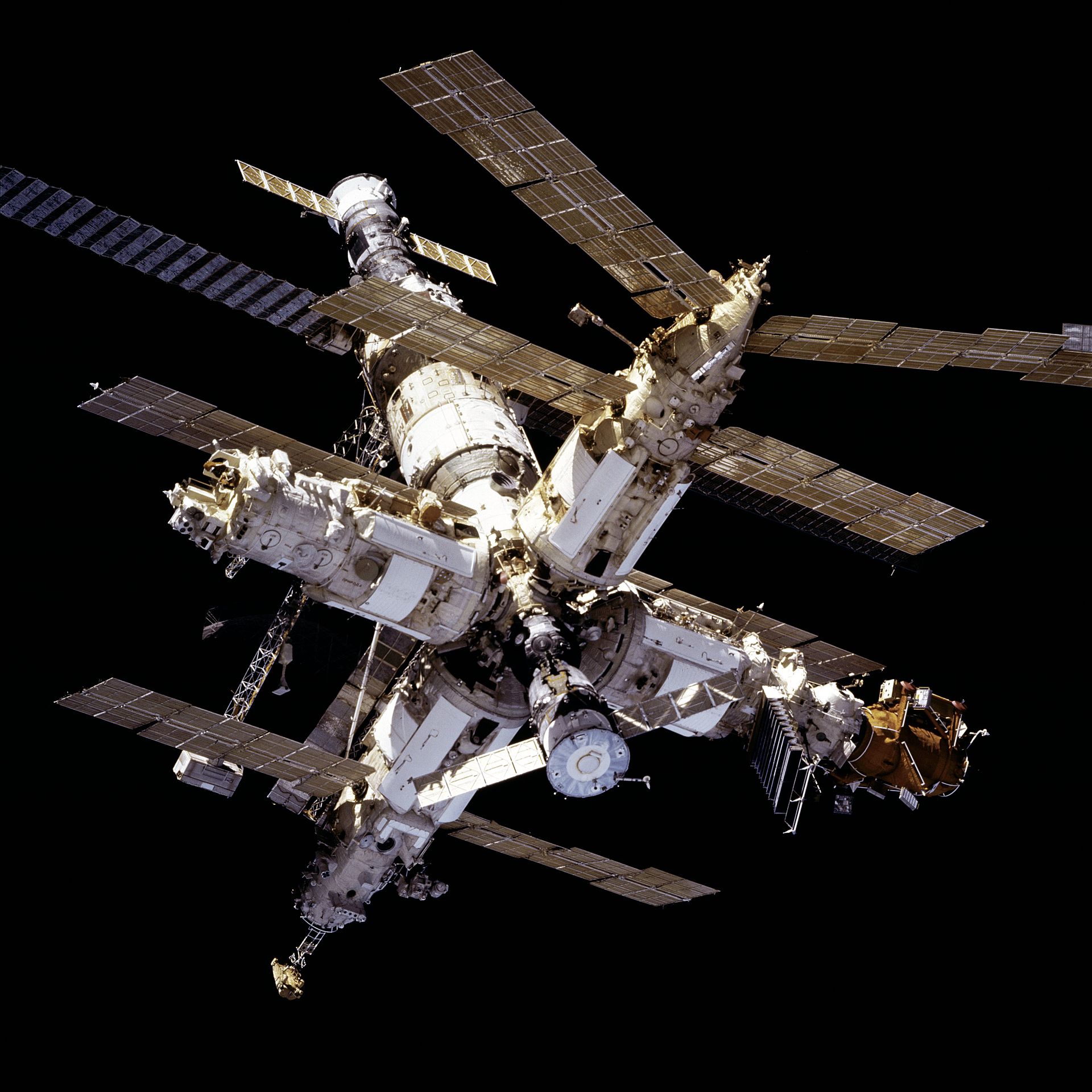 The Mir space station viewed from STS-81 in orbit against the dark void of space